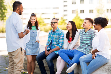 Image showing happy international friends talking in park