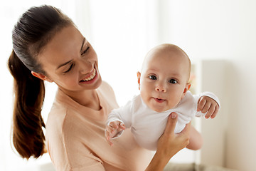 Image showing happy mother playing with little baby boy at home