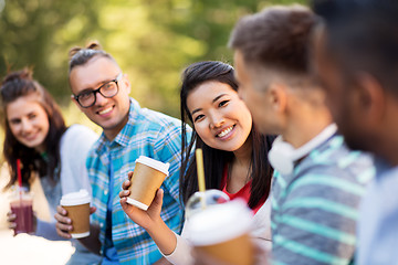 Image showing friends drinking coffee and juice talking in city