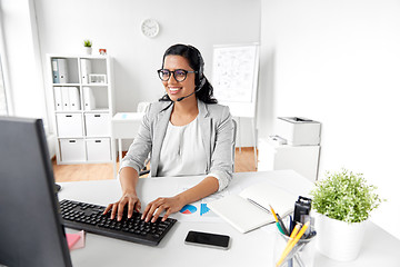 Image showing businesswoman with headset and computer at office