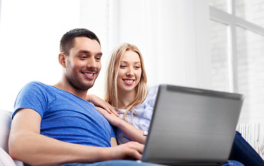 Image showing happy couple with laptop computer at home