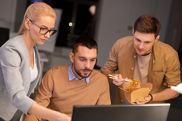 Image showing business team with computer working late at office