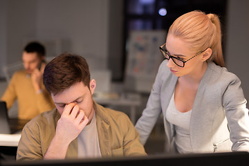 Image showing business team with computer working late at office