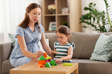 Image showing pregnant mother and daughter with toy blocks