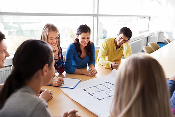 Image showing group of smiling students with blueprint