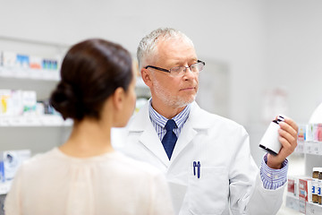 Image showing apothecary and woman with drug at pharmacy