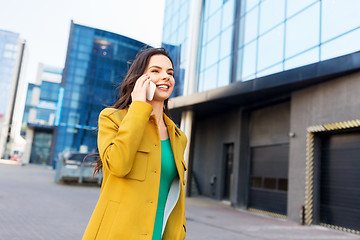 Image showing smiling young woman or girl calling on smartphone