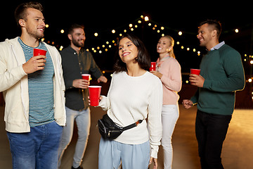 Image showing friends with drinks dancing at rooftop party