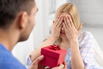 Image showing happy couple with gift box at home