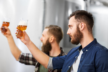 Image showing men drinking and testing craft beer at brewery