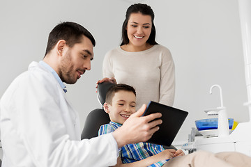 Image showing dentist showing tablet pc to kid at dental clinic