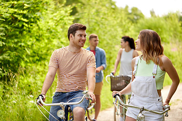 Image showing happy friends riding fixed gear bicycles in summer