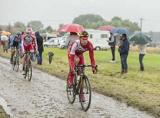 Image showing Group of Cyclists on a Cobblestone Road - Tour de France 2014