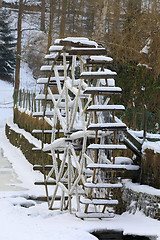 Image showing Small waterwheel in frozen creek in park