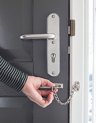 Image showing Door chain on a grey door