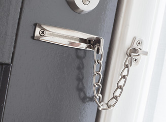 Image showing Door chain on a grey door