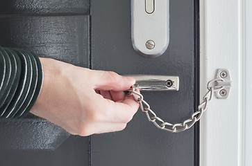 Image showing Door chain on a grey door