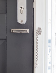 Image showing Door chain on a grey door