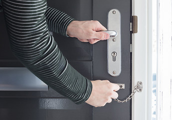 Image showing Door chain on a grey door