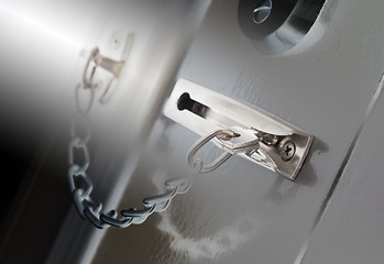 Image showing Door chain on a grey door