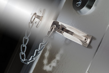 Image showing Door chain on a grey door