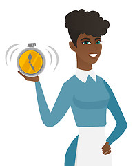 Image showing Young african-american cleaner holding alarm clock