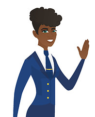 Image showing Young african-american stewardess waving her hand.