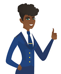 Image showing Young african-american stewardess giving thumb up.