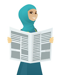 Image showing Young muslim business woman reading newspaper.