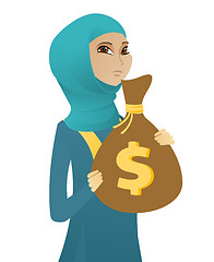 Image showing Upset muslim business woman with bag full of taxes