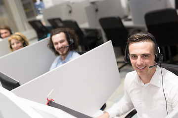 Image showing male call centre operator doing his job