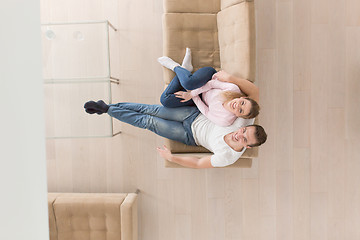 Image showing Young couple on the sofa watching television top view