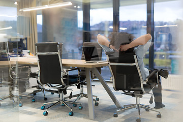 Image showing young businessman relaxing at the desk