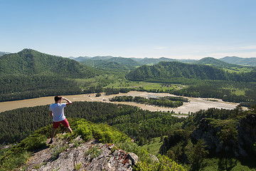 Image showing Man standing on top of cliff