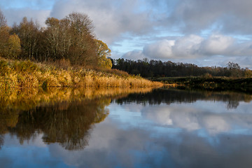 Image showing Autumn landscape with colorful trees and river. Reflection in ri