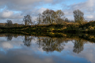 Image showing Autumn landscape with colorful trees and river. Reflection in ri