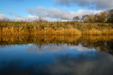 Image showing Autumn landscape with colorful trees and river. Reflection in ri