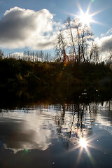 Image showing Autumn landscape with colorful trees and river. Evening reflecti