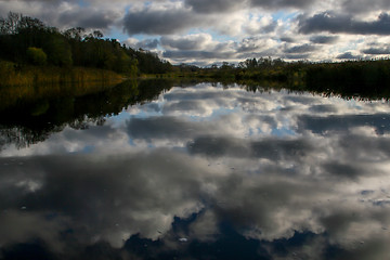 Image showing Autumn landscape with colorful trees, grass and river. Reflectio