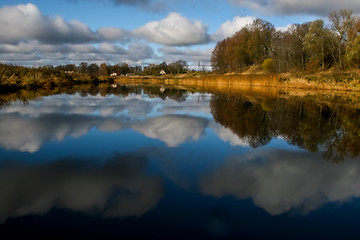 Image showing Autumn landscape with colorful trees, yellow grass and river. Re