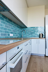 Image showing White glossy kitchen with modern appliances