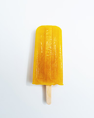 Image showing Ice lollies. Orange fruit ice cream presented on a white background with copy space. Top view