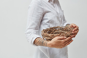 Image showing Girl holding a wreath in her hands