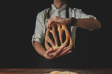 Image showing Baker holding fougas bread