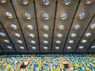 Image showing KYIV, UKRAINE - July 19, 2018. Elements of roof construction the stadium NSC Olimpiysky with empty tribunes in blue and yellow colors before the game.