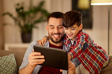 Image showing father and son with tablet pc playing at home