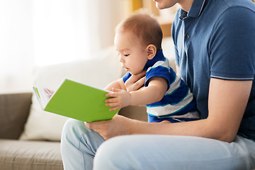 Image showing baby boy and father with book at home