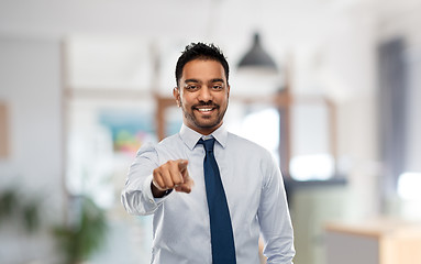 Image showing businessman pointing to you over office