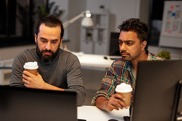 Image showing creative team drinking coffee at night office