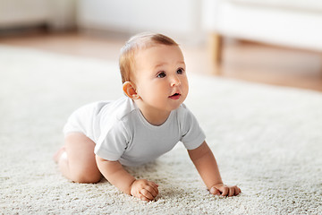 Image showing little baby crawling on floor at home